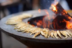 bigstock-Traditional-Fried-Fish-Being-C-292158643-250x167